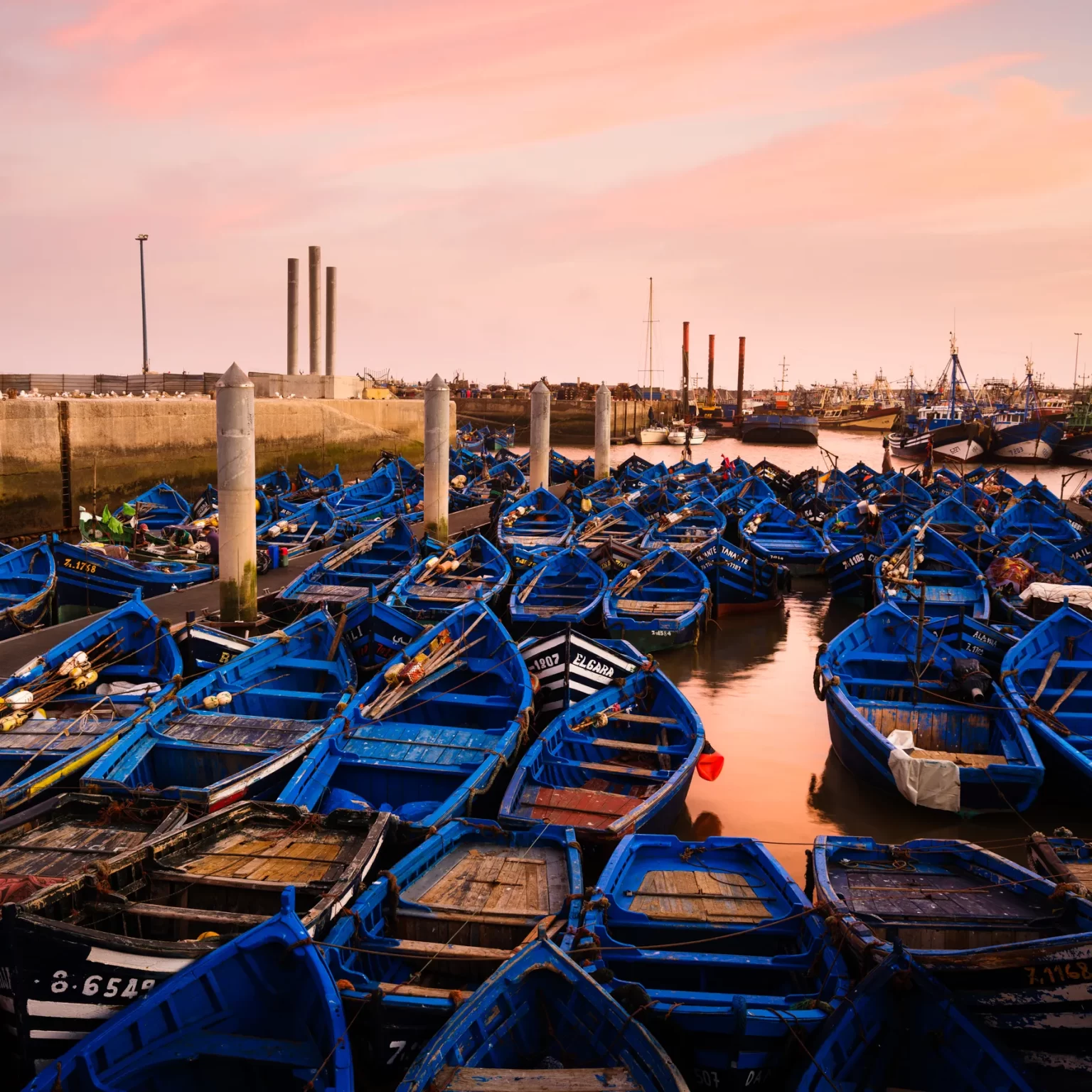 1. A multitude of boats gathered on the water, creating a vibrant scene of maritime activity and movement while your 16-day Morocco luxury tour from Casablanca