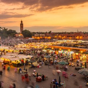 Sunset over Marrakech, Morocco, showcasing vibrant colors illuminating the city's historic architecture and bustling streets in Jamaa Lefna Square is one of the best things to do in Marrakech